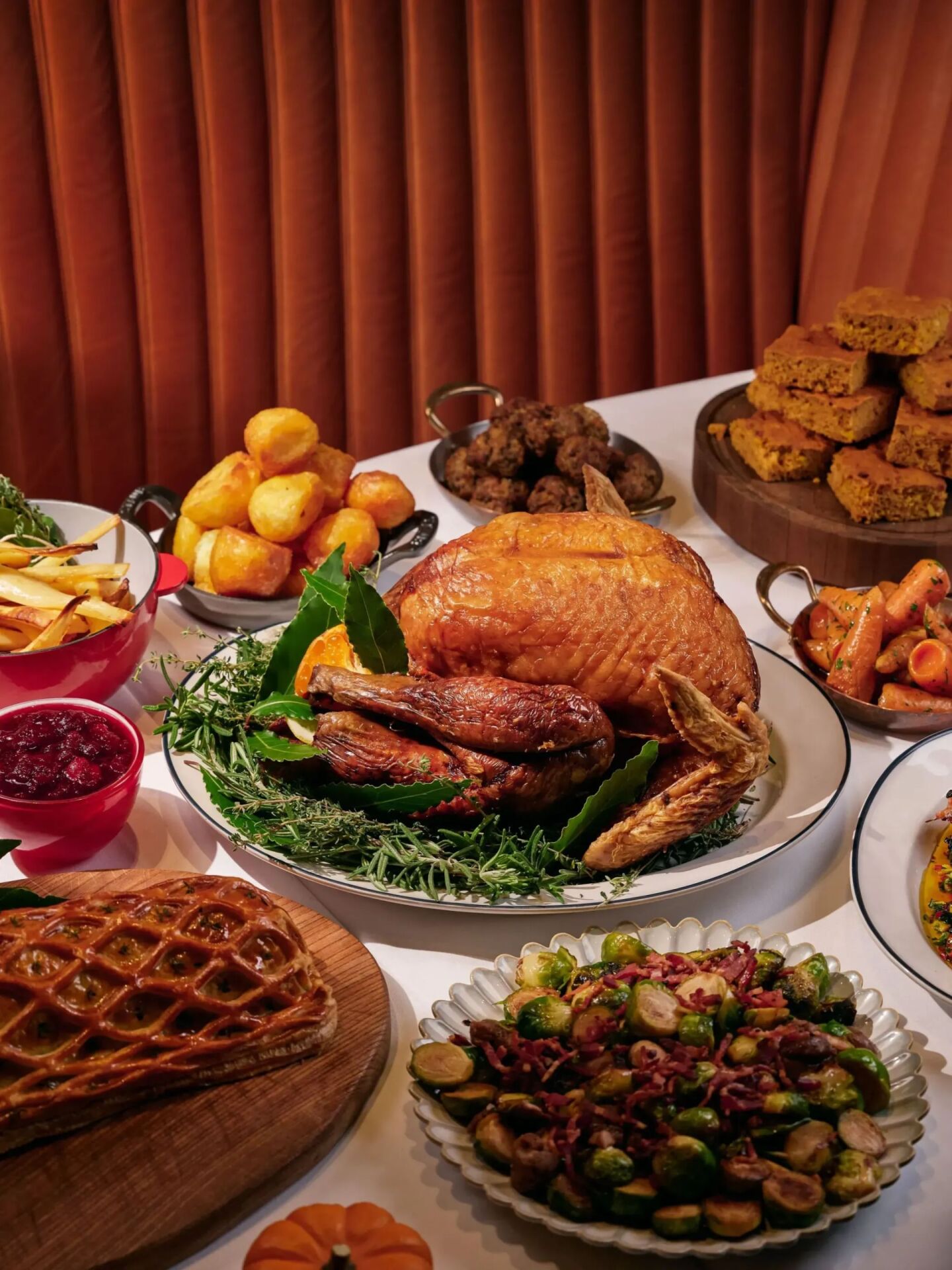 Multiple Thanksgiving dishes on white table cloth at The Grill at The Dorchester