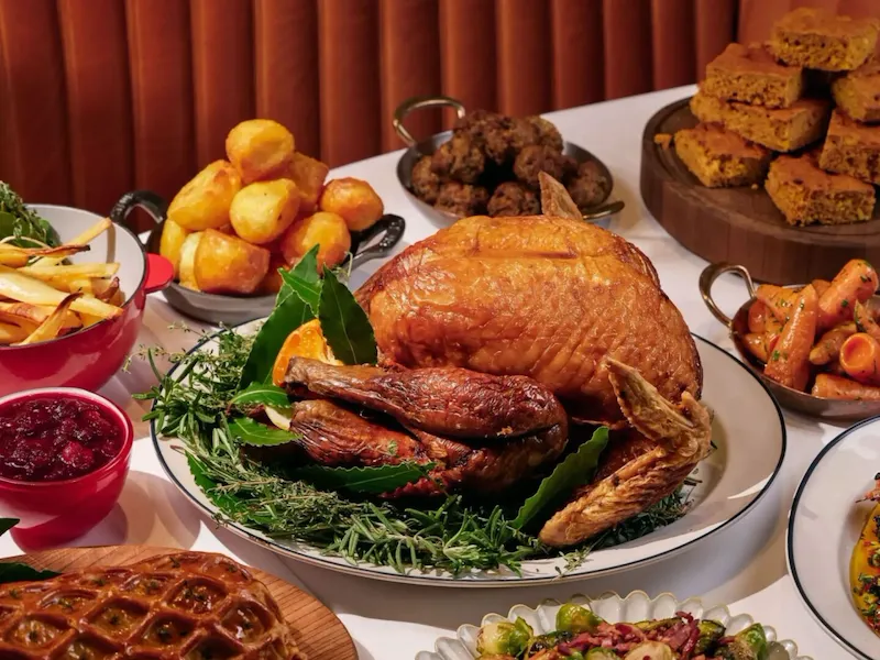 Multiple Thanksgiving dishes on white table cloth at The Grill at The Dorchester