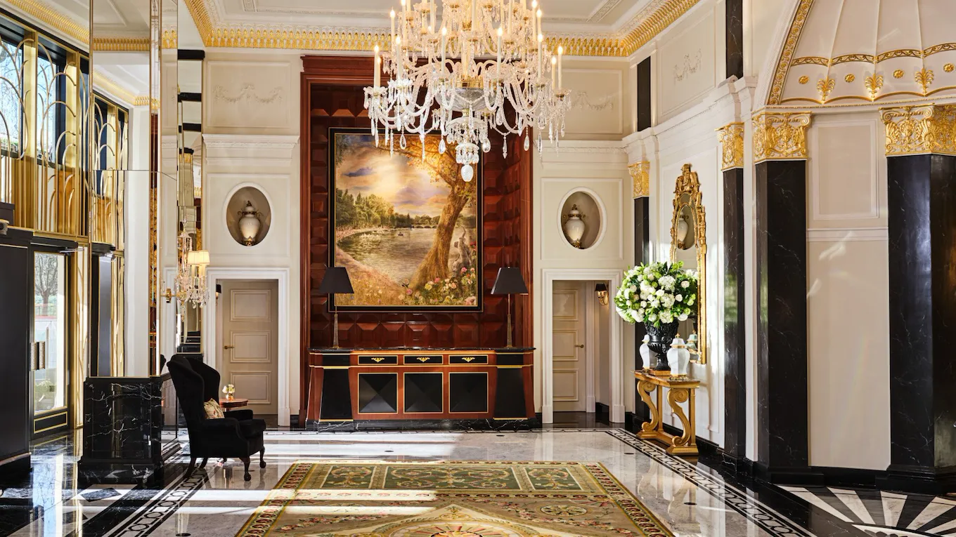 The Dorchester Lobby with reception desk and concierge desk in afternoon sunlight