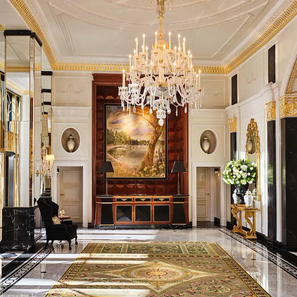 The Dorchester Lobby with reception desk and concierge desk in afternoon sunlight