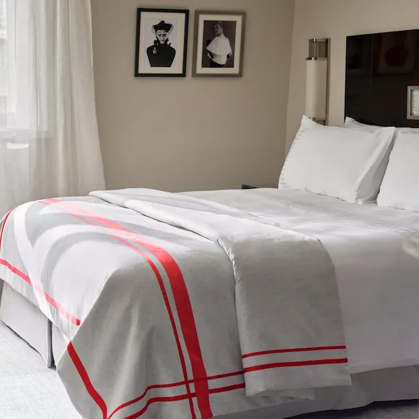 Photo of the bed in the superior rooms with an art deco style