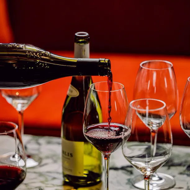 Wine being poured into glass at Bar Nineteen12 at The Beverly Hills Hotel