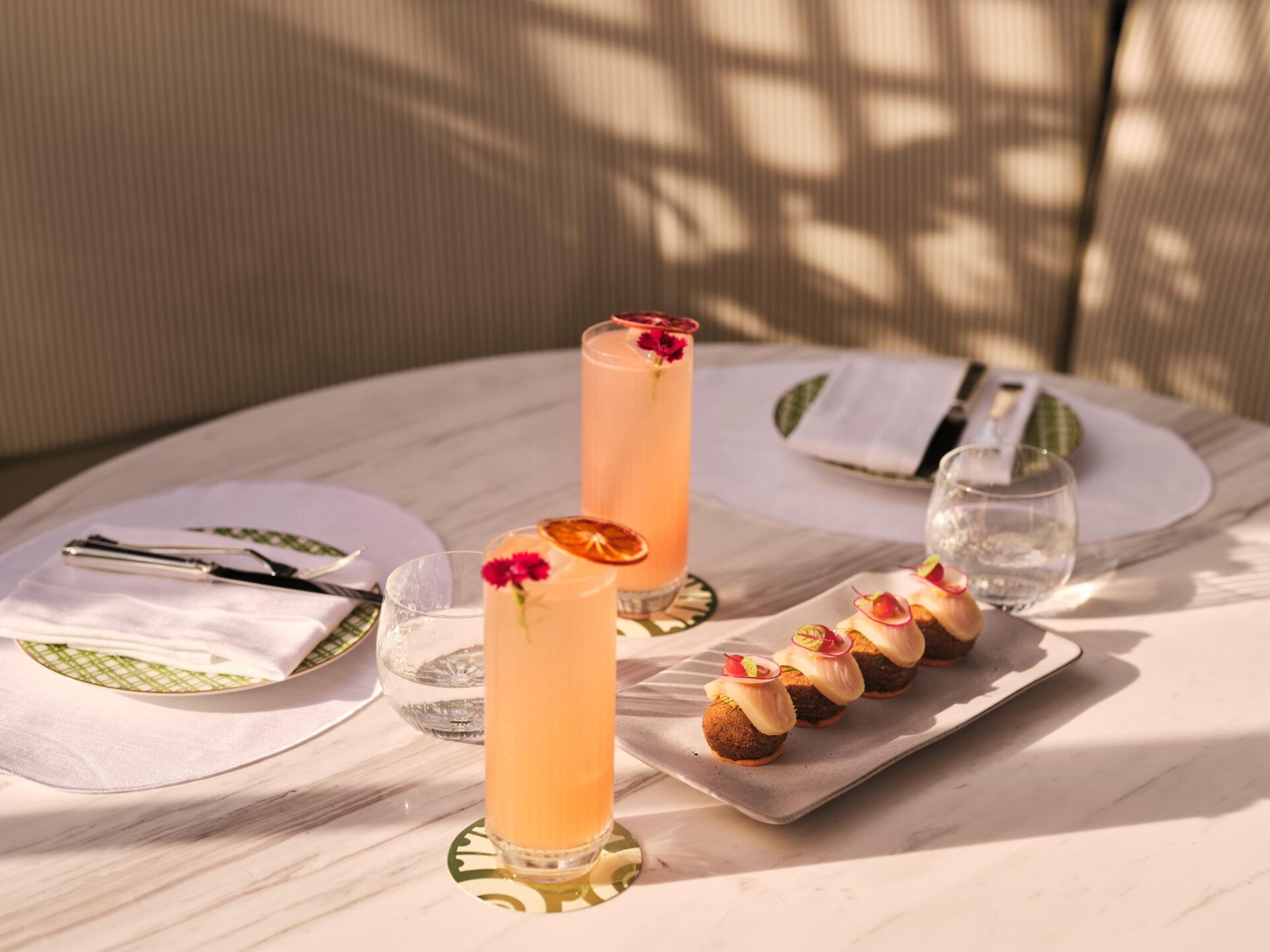 Image of Veranda design and food at The Lana - Dorchester Collection