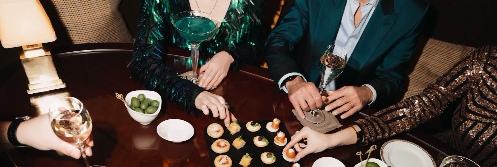 Detail of canapes and cocktails on a brown table at Principe Bar