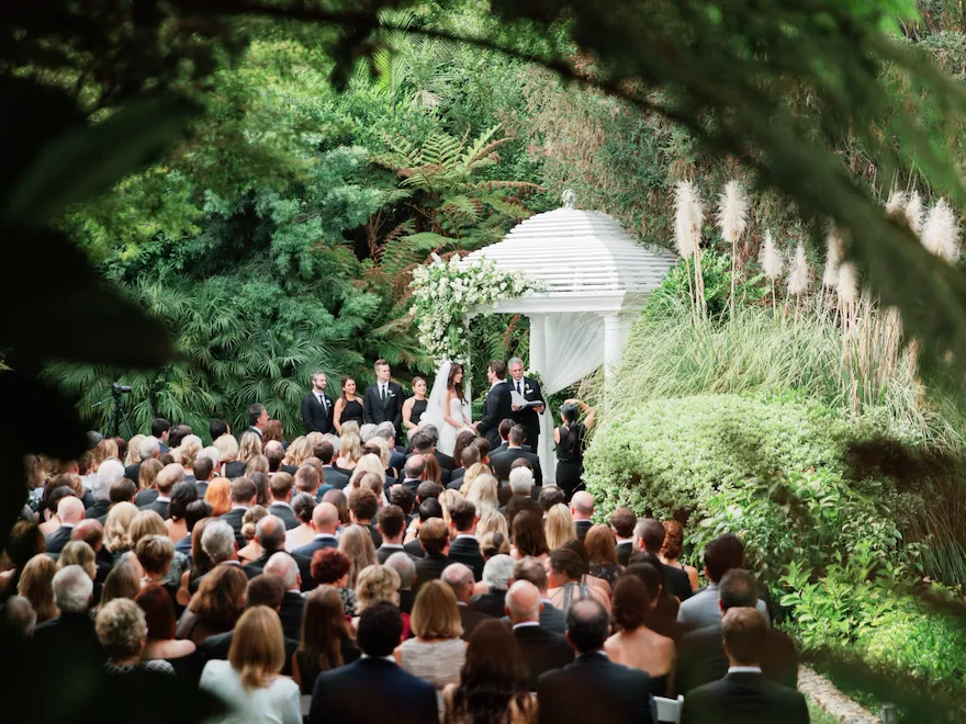 Crowd gathers on Swan Lake for wedding at Hotel Bel-Air