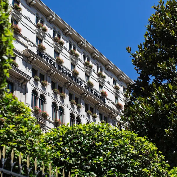 Exterior of Hotel Principe Di Savoia from ground level on a sunny day, Milan