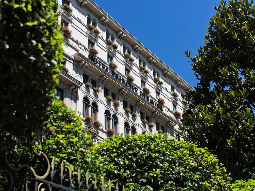 Exterior of Hotel Principe Di Savoia from ground level on a sunny day, Milan