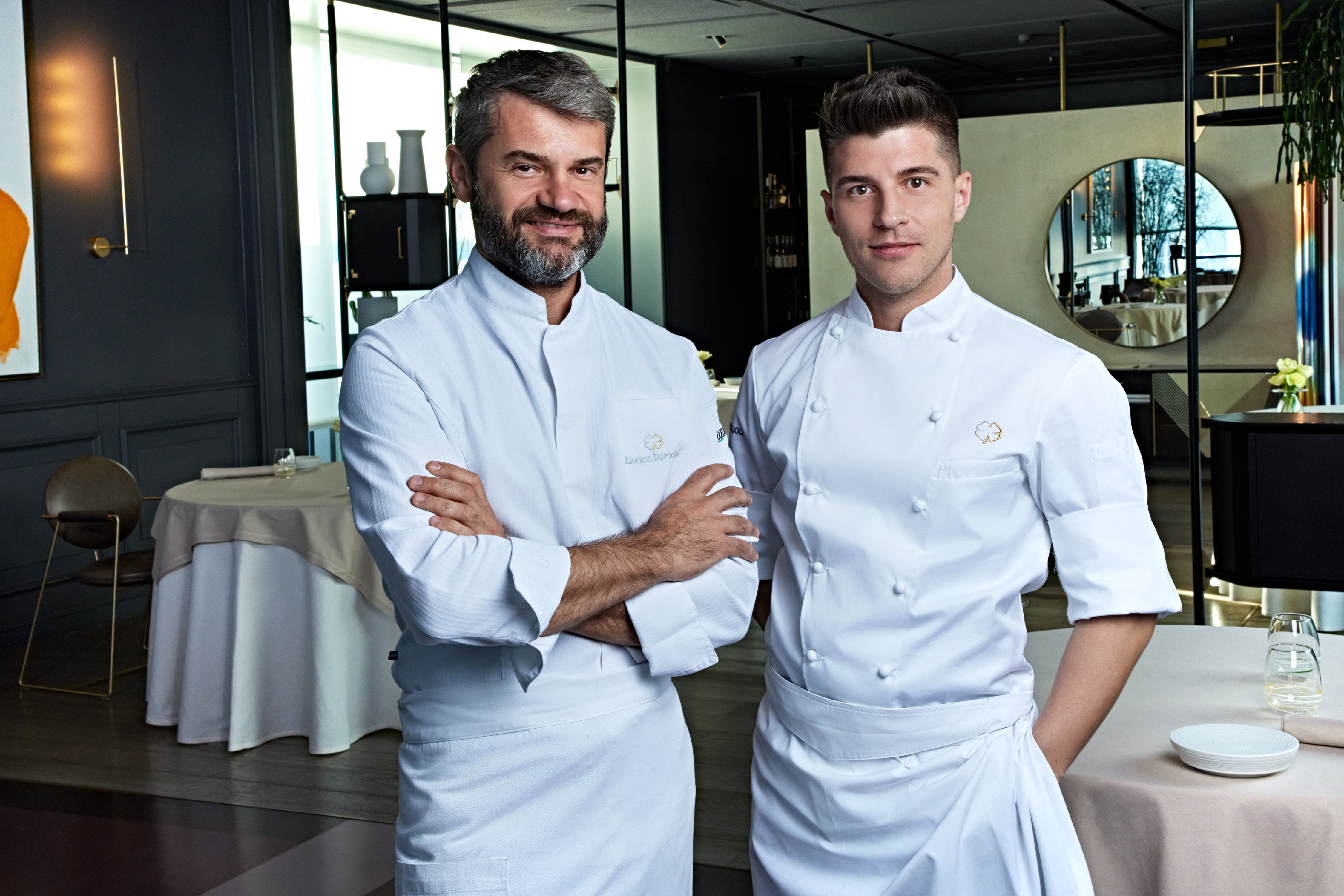 2 chefs standing in a restaurant. 