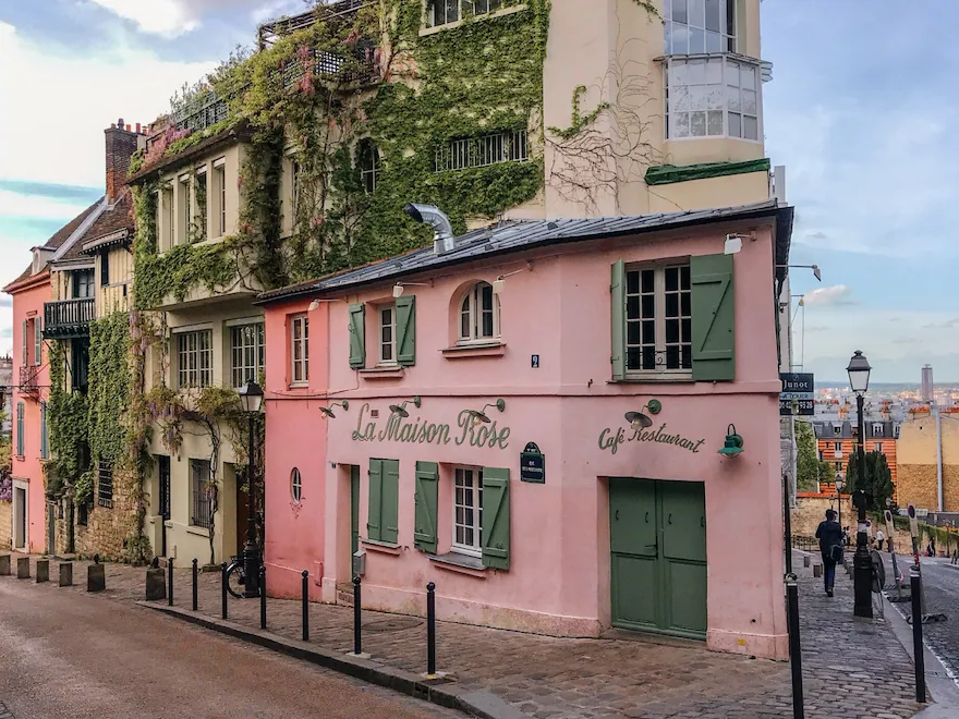 La Maison Rose restaurant façade in Montmartre, a piink façade with green doors and windows, at La Maison Rose, Paris.