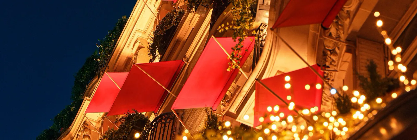 Picture of the facade during Christmas with red stores.