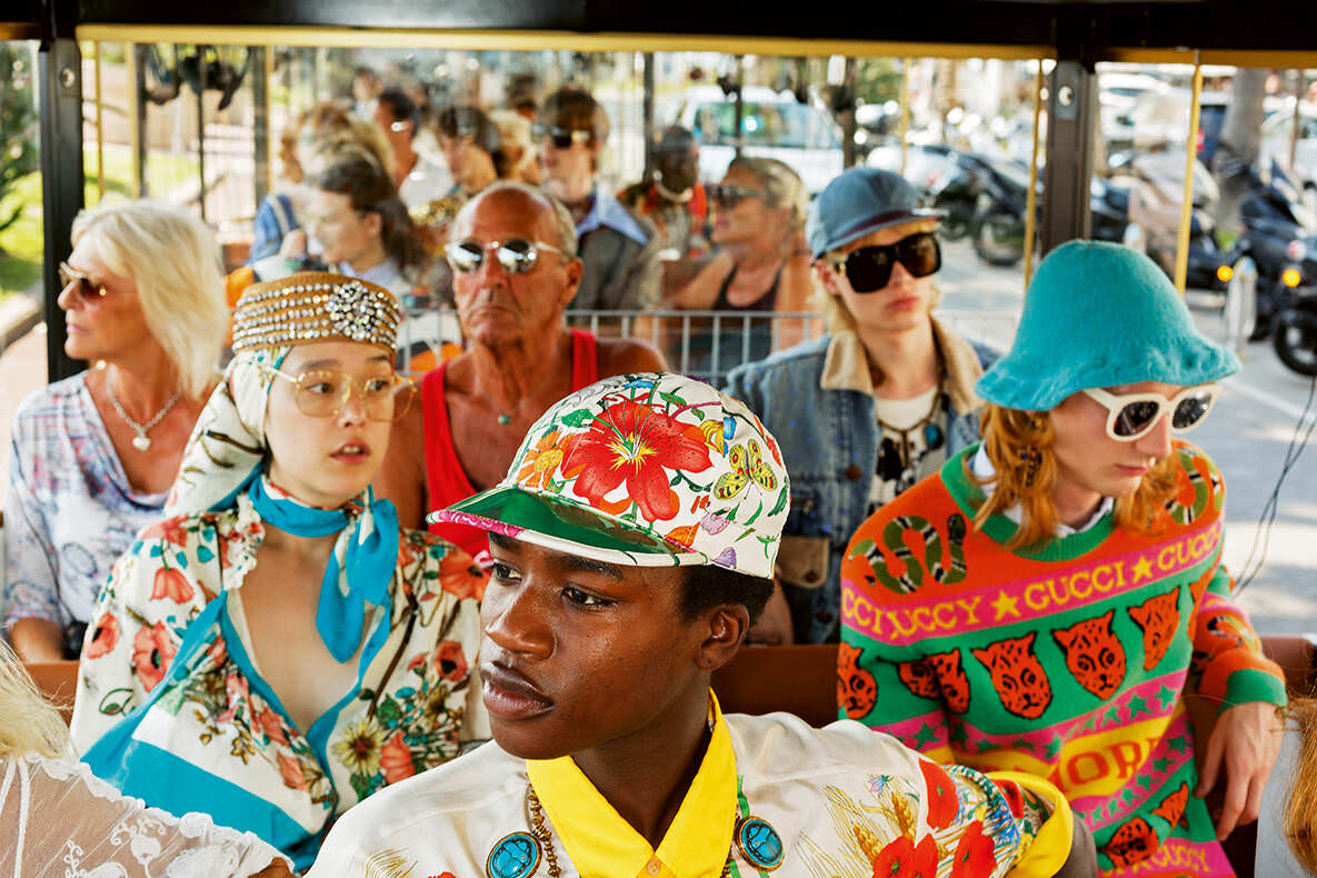 Photo by Martin Parr, people in a bus wearing colorful clothes