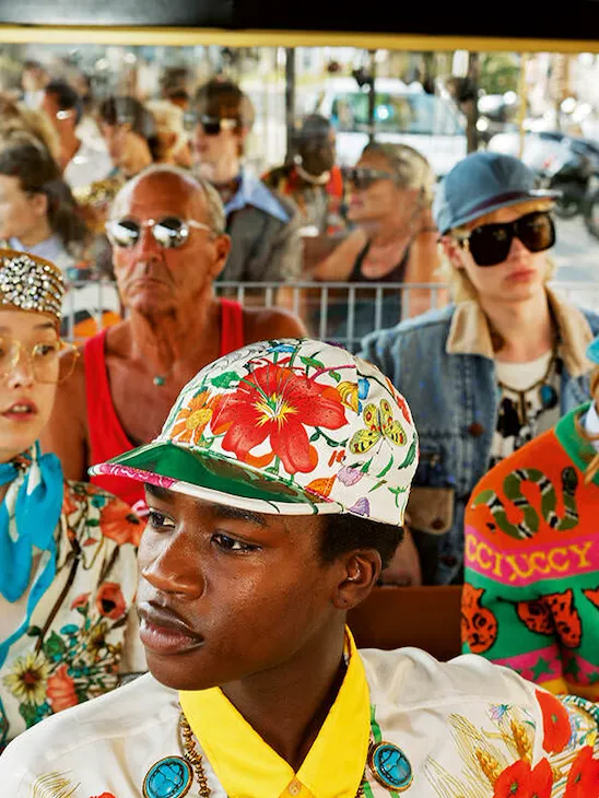 Photo by Martin Parr, people in a bus wearing colorful clothes