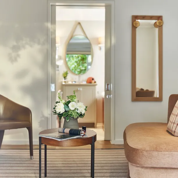 Stable Junior suite at coworth park sitting area with sofas