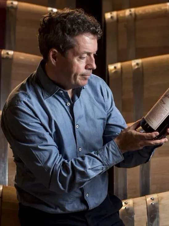 Peter Gago in his winery holding one of his wine bottles