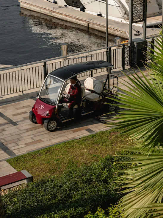 The Lana's golf cart passing in front of the marina.