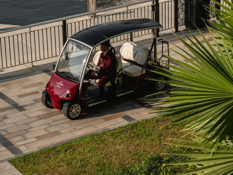 The Lana's golf cart passing in front of the marina.