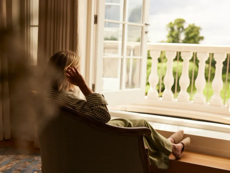 family relaxing and playing in room at Coworth Park