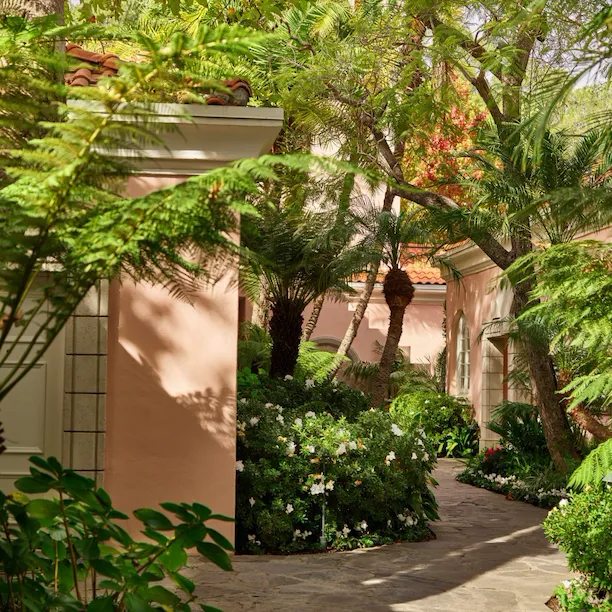 Garden pathways lead to rooms, suites and fountains