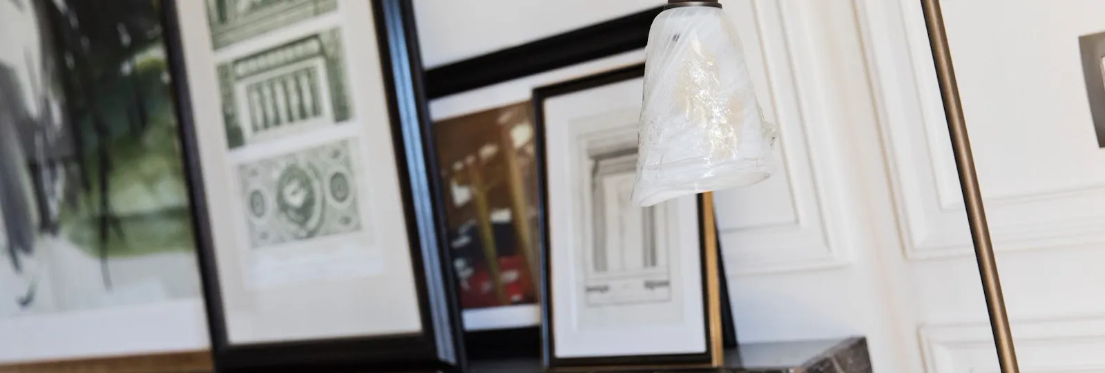 Detail of suite's living room with lamp, couch and paintings at Hotel Eden, Rome