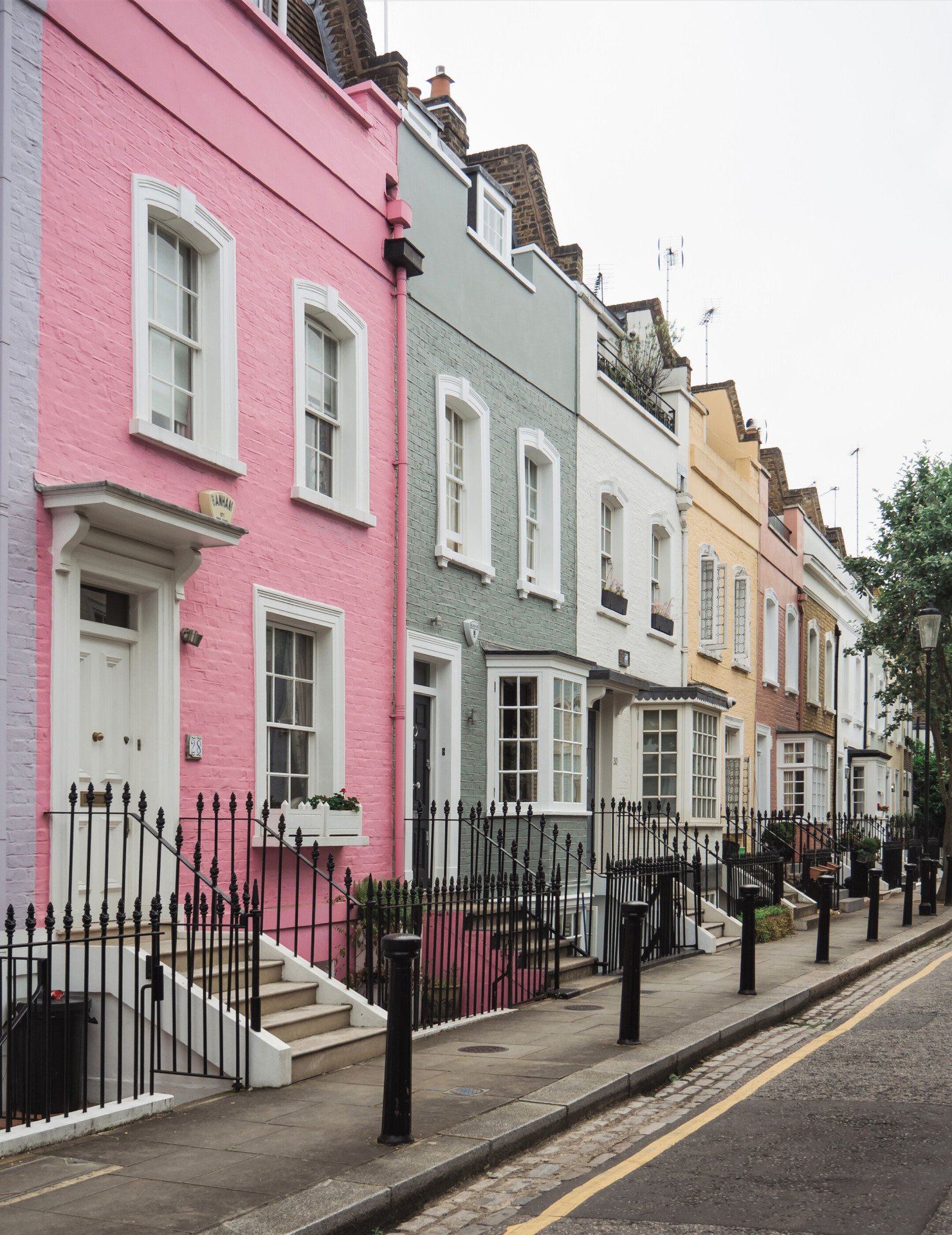Coloured terrace houses on a street in Bywater Street in Primrose Hill, London