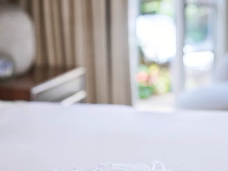 Bungalow 22A detail of crest on bed at The Beverly Hills Hotel, Los Angeles