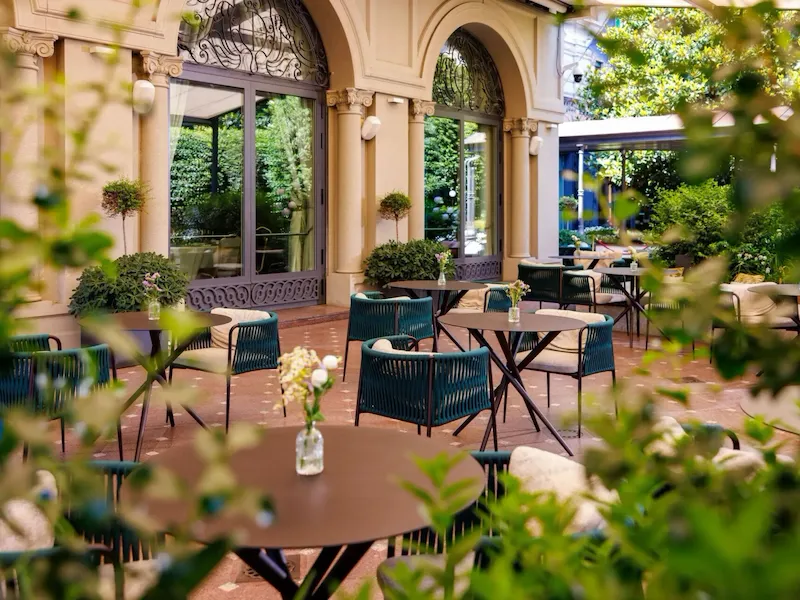 Veranda garden with tables decorated with colorful flower pots