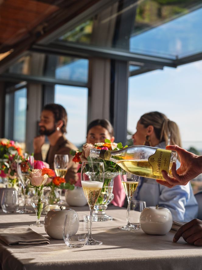 Waiter serving prosecco at La Terrazza