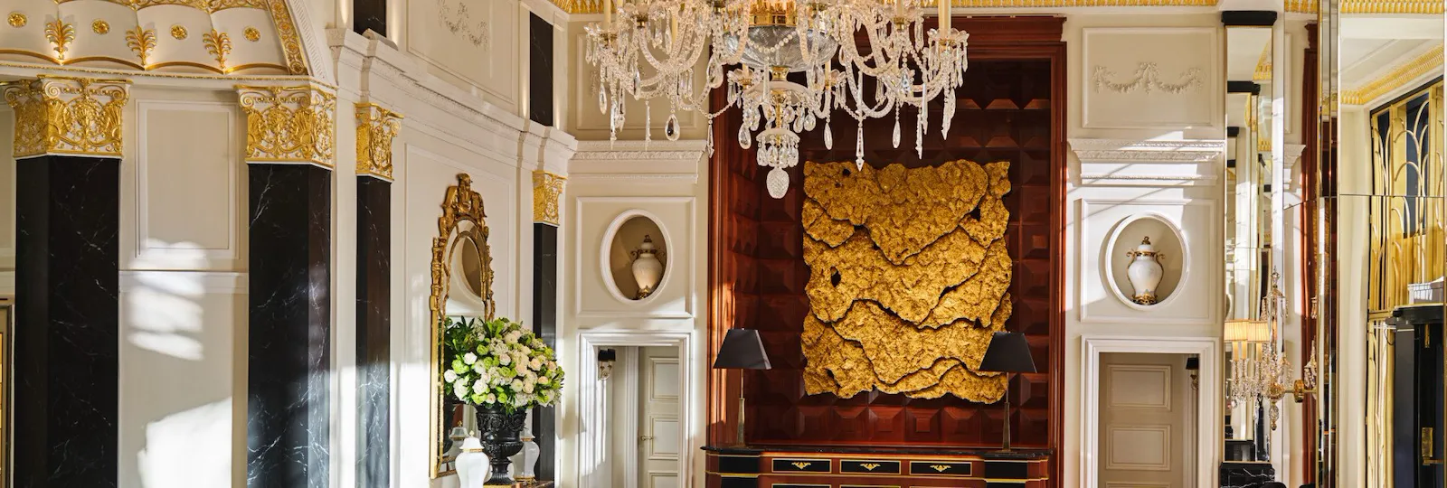 The Dorchester Lobby with reception desk and concierge desk in afternoon sunlight