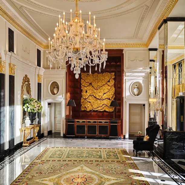 The Dorchester Lobby with reception desk and concierge desk in afternoon sunlight