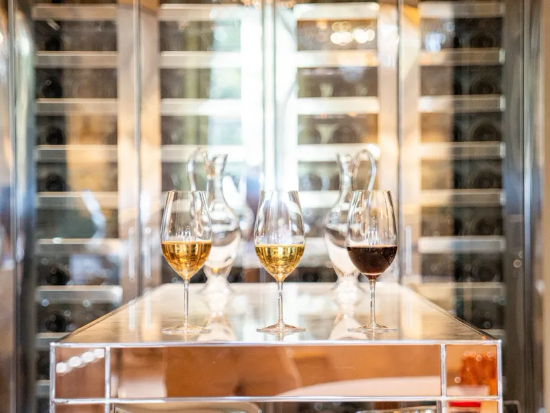 Three glasses of white and red wines in the wine cellar of Restaurant Le Meurice Alain Ducasse, at Le Meurice, Paris.