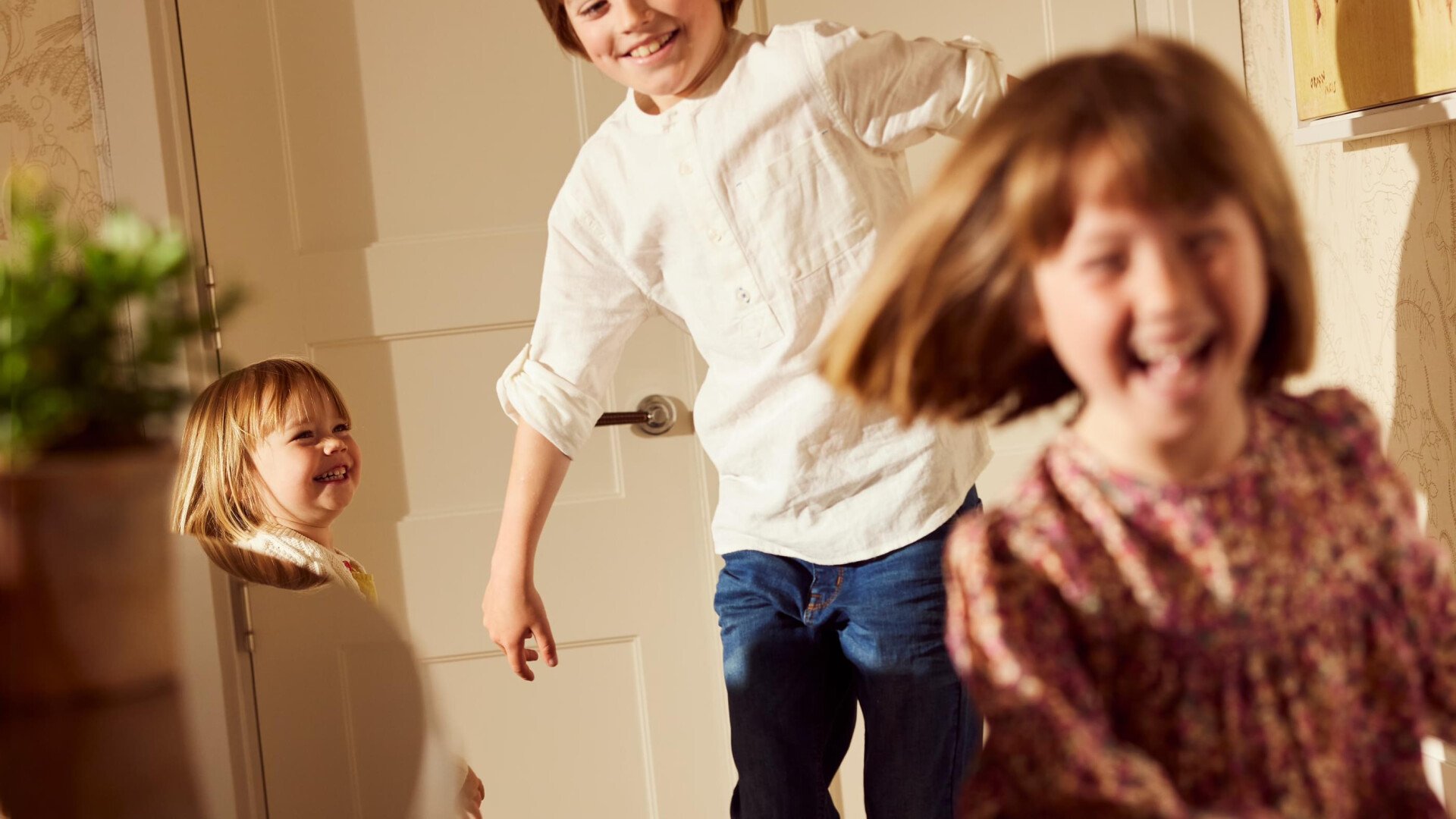 family relaxing and playing in room at Coworth Park