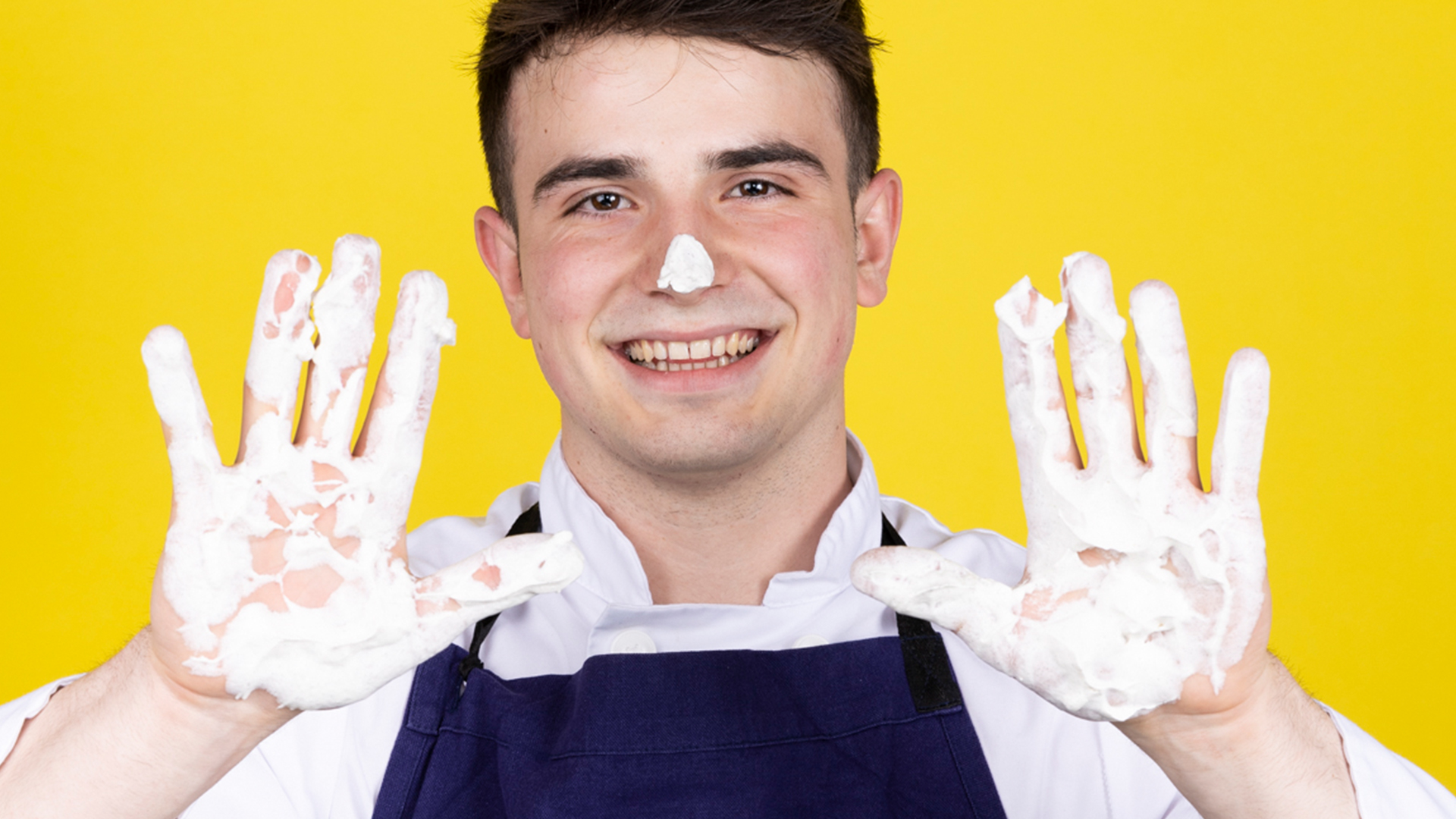 A young man showing his hand with full of paint