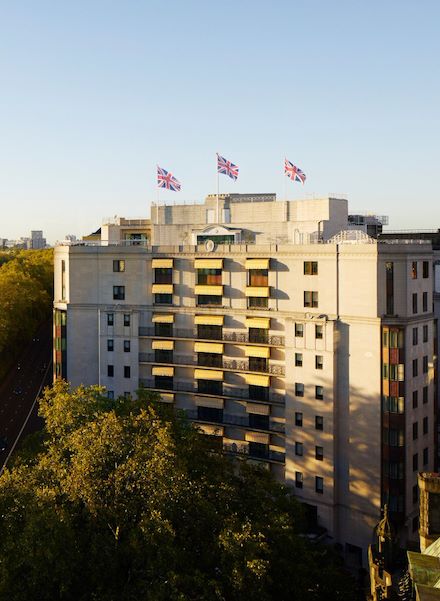 The Dorchester building exterior at sunset next to Hyde Park, London