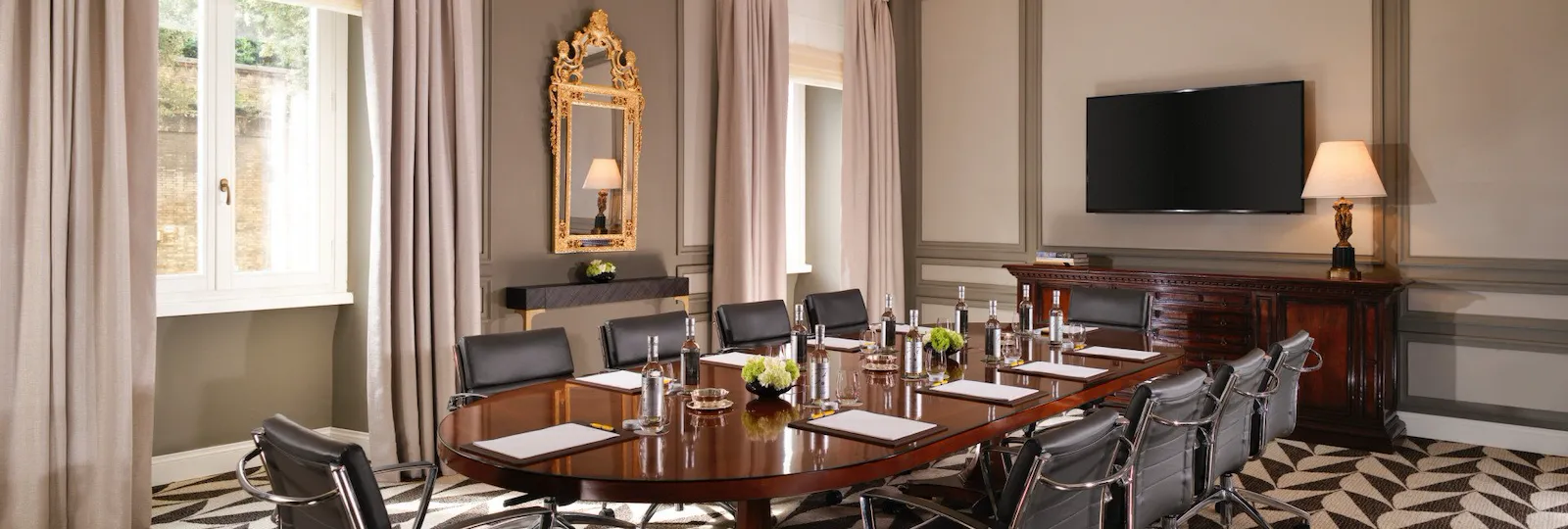 Sala Ludovisi meeting room with table, chairs and screen on wall at Hotel Eden, Rome