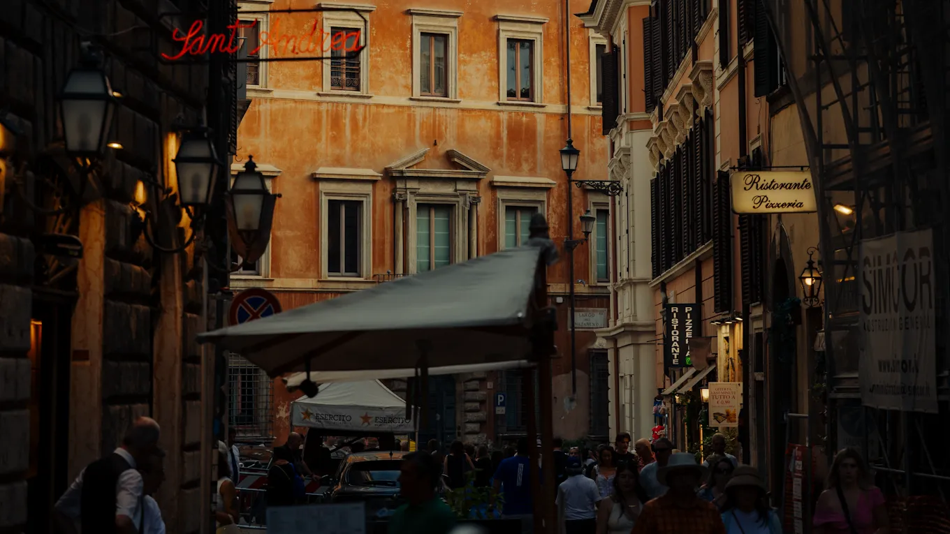 People walk through a busy city alley with signs and buildings, lively and vibrant atmosphere