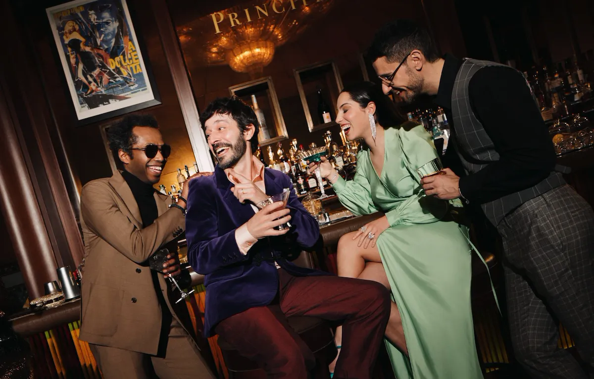 A group of people celebrating and drinking cocktails at Principe Bar