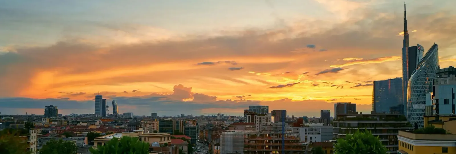 view from Hotel Principe di Savoia rooftop on Porta Nuova district with sunset