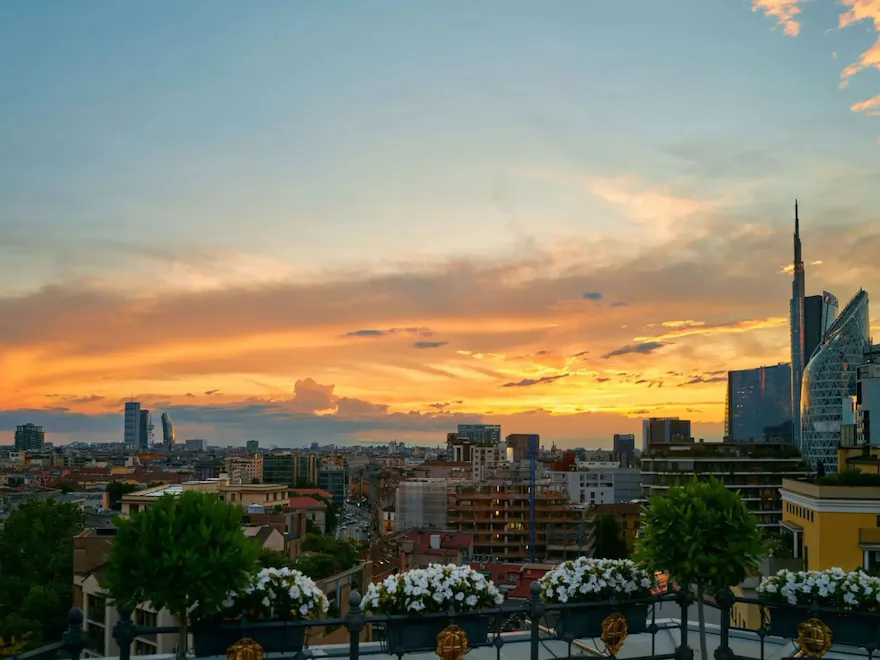 view from Hotel Principe di Savoia rooftop on Porta Nuova district with sunset