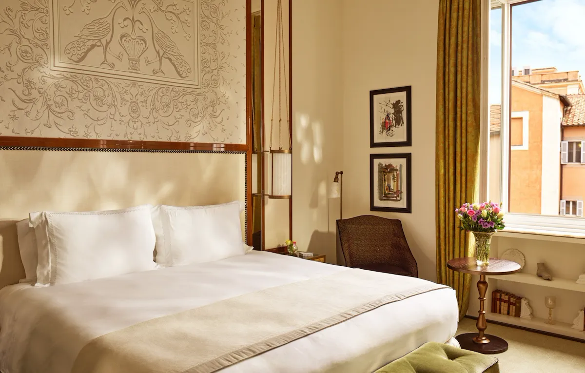 Bedroom of prestige room, headboard with peacocks illustration and window with view, at Hotel Eden, Rome