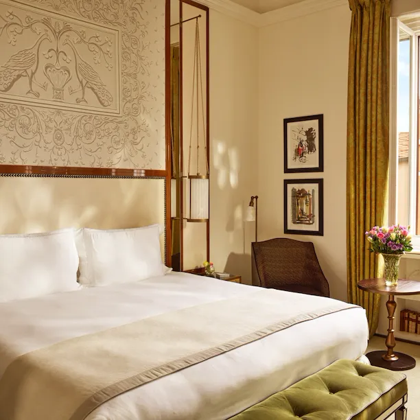 Bedroom of prestige room, headboard with peacocks illustration and window with view, at Hotel Eden, Rome