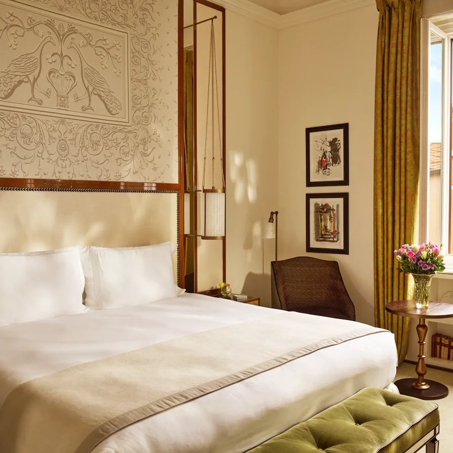 Bedroom of prestige room, headboard with peacocks illustration and window with view, at Hotel Eden, Rome