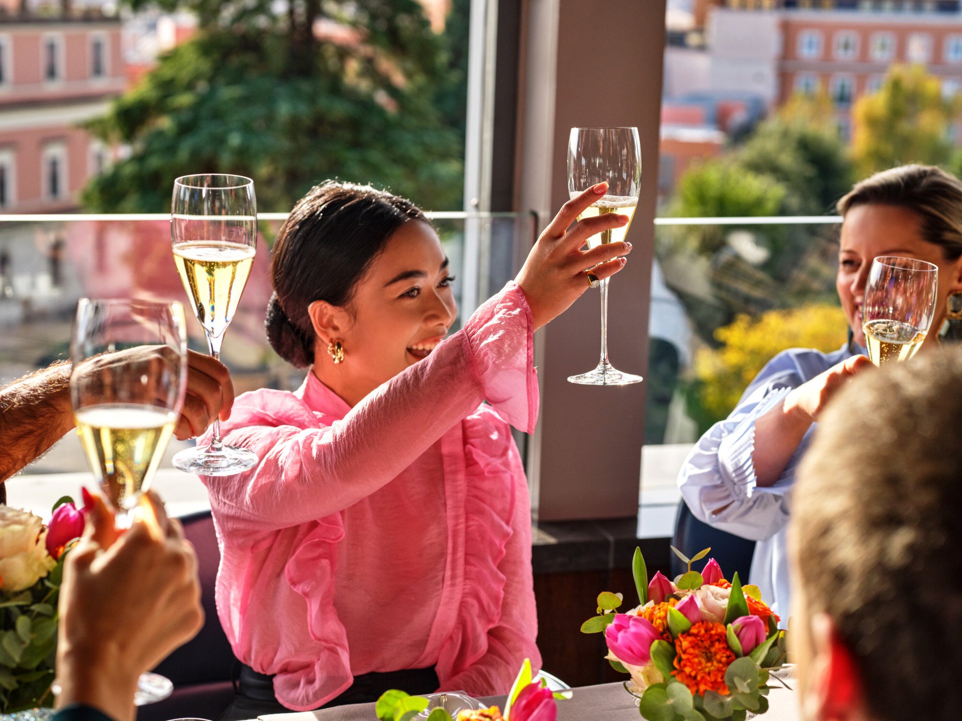 Smiling girl rising her Champagne glass at La Terrazza 