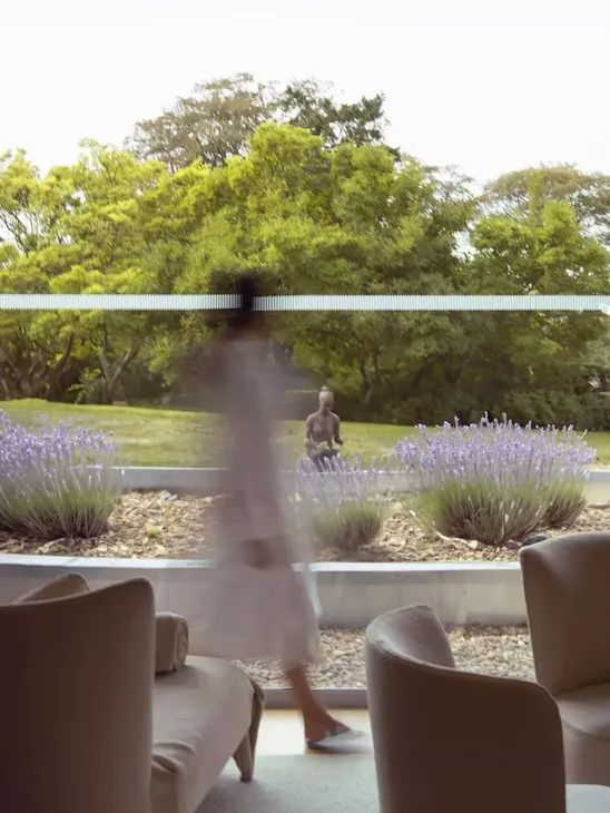 Model walking through relaxation room at The Spa at Coworth Park