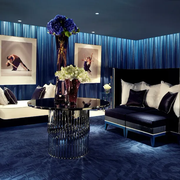A welcoming, comfortable low-lit room in deep blue tones