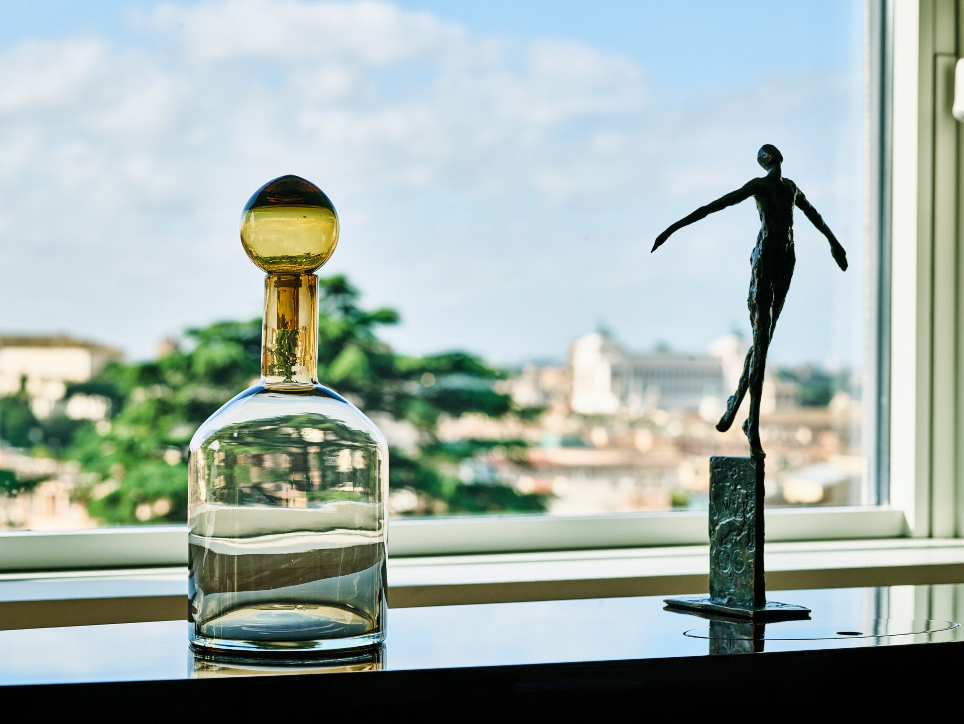 Sculpture and glass vase by the window at Bellavista Penthouse Suite at Hotel Eden, Rome