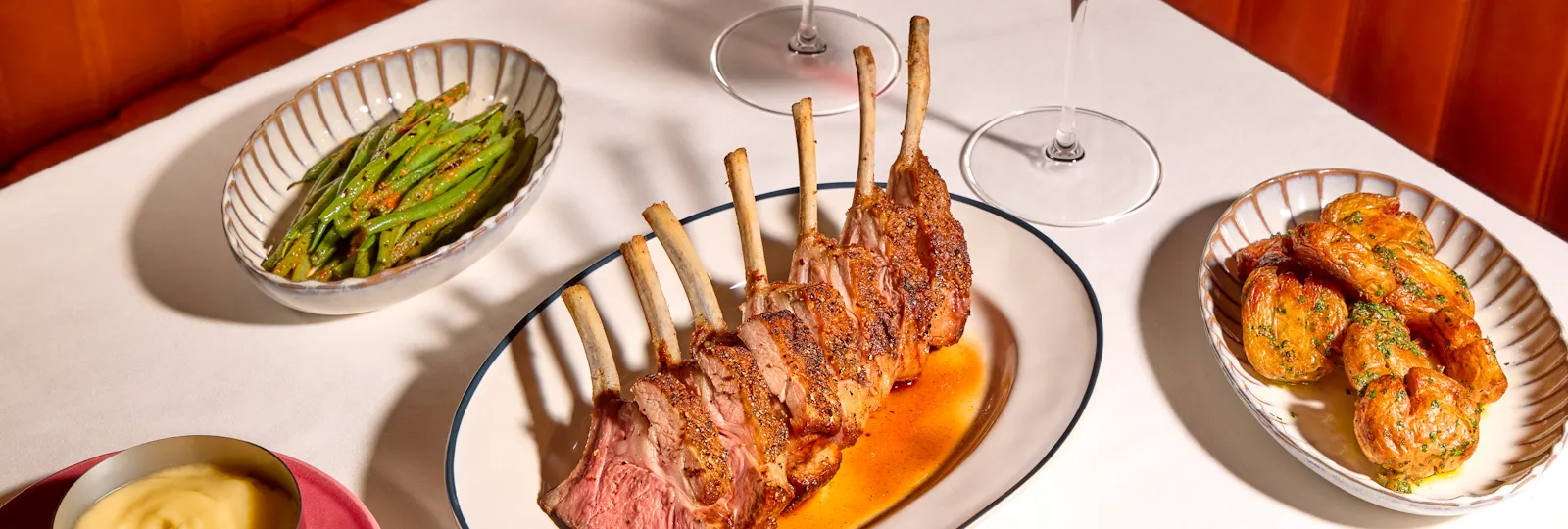 Rack of lamb at The Grill at The Dorchester, served with asparagus, roast potatoes, red wine and seasonal accompaniments.