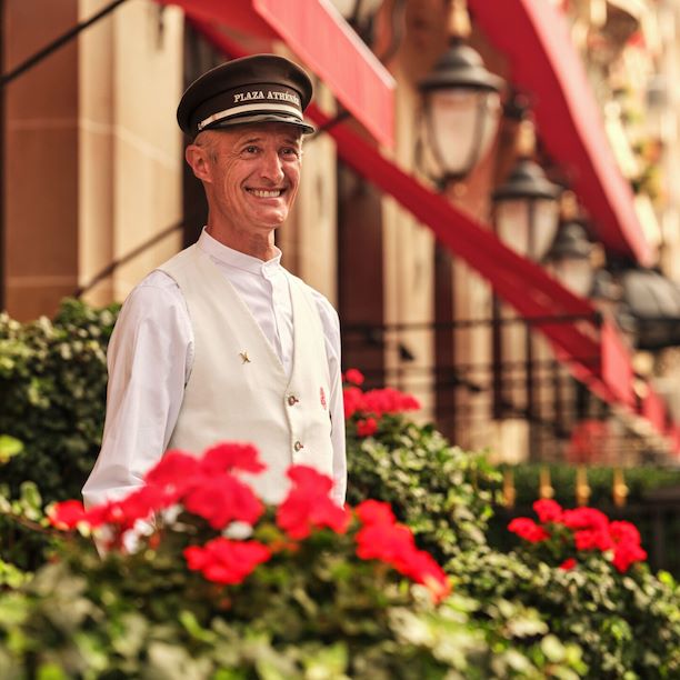 This is a close-up shot of the doorman in front of the entrance of the Plaza Athénée. 