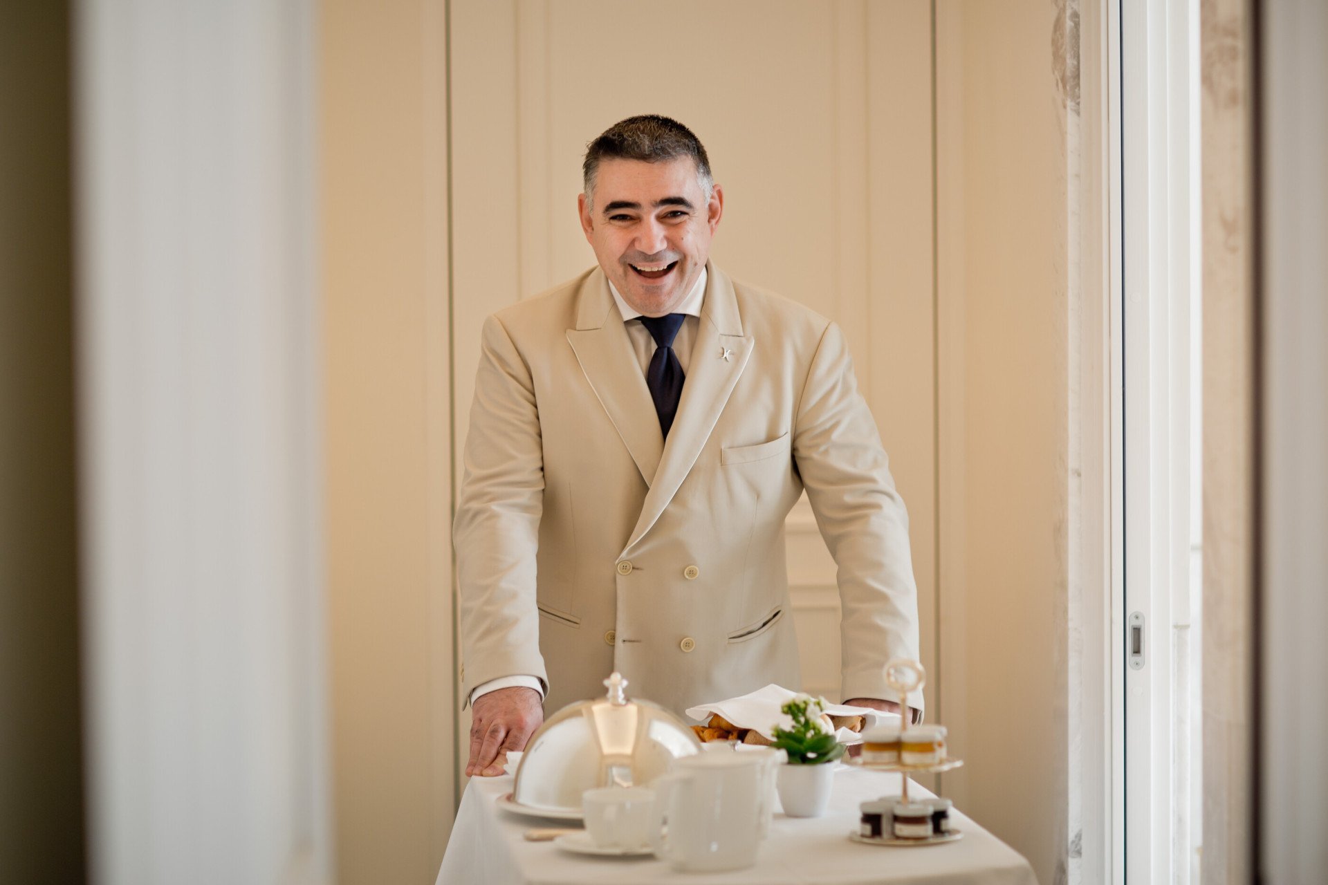Portrait of waiter carrying in room dining cart at Hotel Eden, Rome