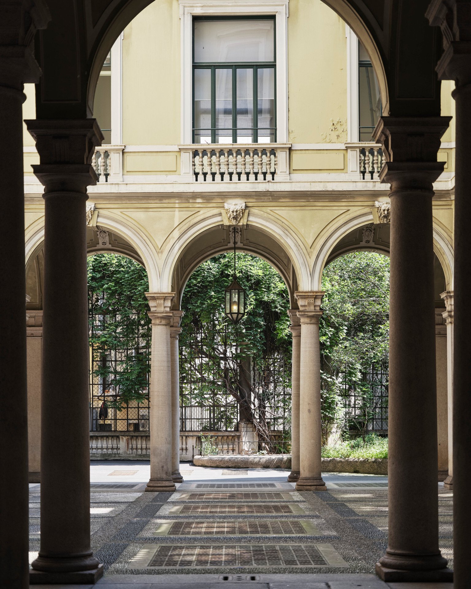 View of a Brera courtyard with arches and plants 