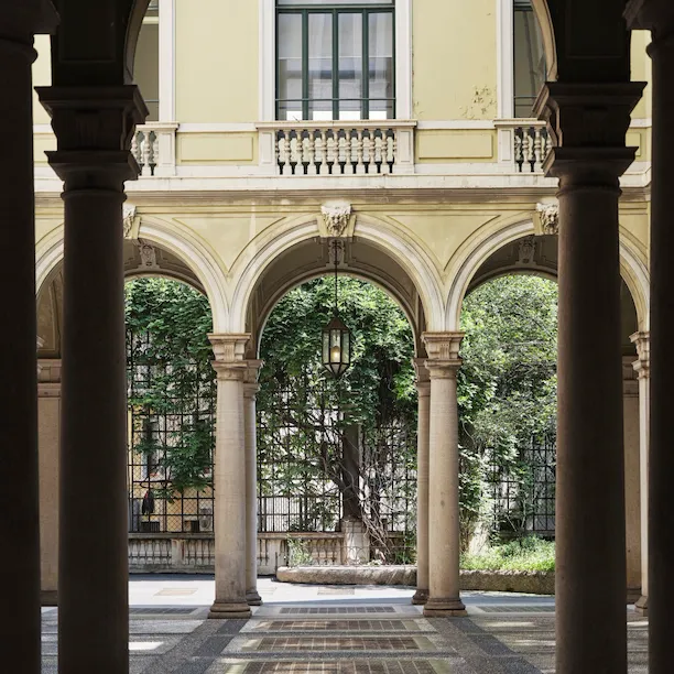 View of a Brera courtyard with arches and plants